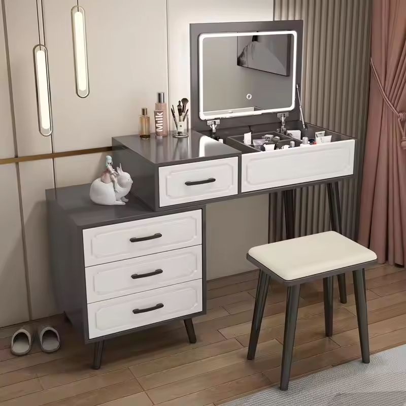 The Modern Bedroom Dressing Table is a stylish and functional furniture piece designed to enhance the beauty, organization, and convenience of your bedroom. Featuring a contemporary design with ample storage space, this dressing table provides the perfect area for makeup application, grooming, skincare routines, and organizing personal accessories. Crafted from high-quality materials, the dressing table offers exceptional durability, stability, and long-lasting performance. Its spacious tabletop provides enough room for cosmetics, perfumes, beauty products, jewelry, and decorative items, while the integrated drawers help keep essentials neatly organized and easily accessible. The sleek modern design complements a wide range of bedroom interiors, including contemporary, minimalist, Scandinavian, and luxury décor styles. Whether placed in a master bedroom, guest room, apartment, or dressing area, this dressing table adds elegance and functionality to your space. Designed to maximize organization while enhancing room aesthetics, the Modern Bedroom Dressing Table is an excellent choice for homeowners seeking practical storage and sophisticated style. Key Features Modern and elegant bedroom design Spacious tabletop for beauty essentials Multiple storage drawers for organization Durable and sturdy construction Smooth and easy-to-clean surface Suitable for makeup, grooming, and skincare routines Space-saving and functional design Complements modern and classic bedroom décor Long-lasting quality craftsmanship Ideal for homes, apartments, and guest rooms
